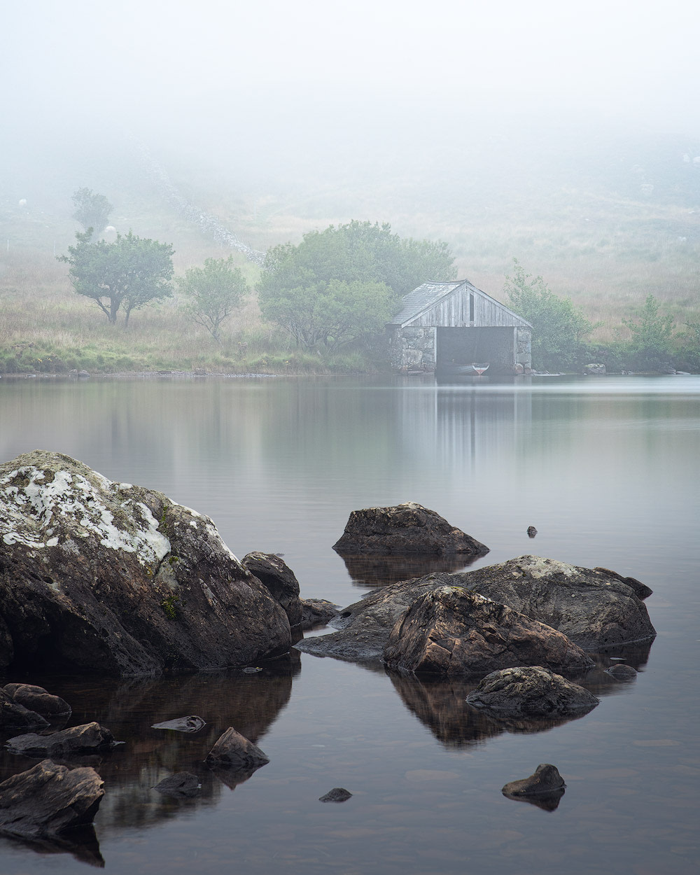 Foggy conditions around the boat house at Cregennan Lakes